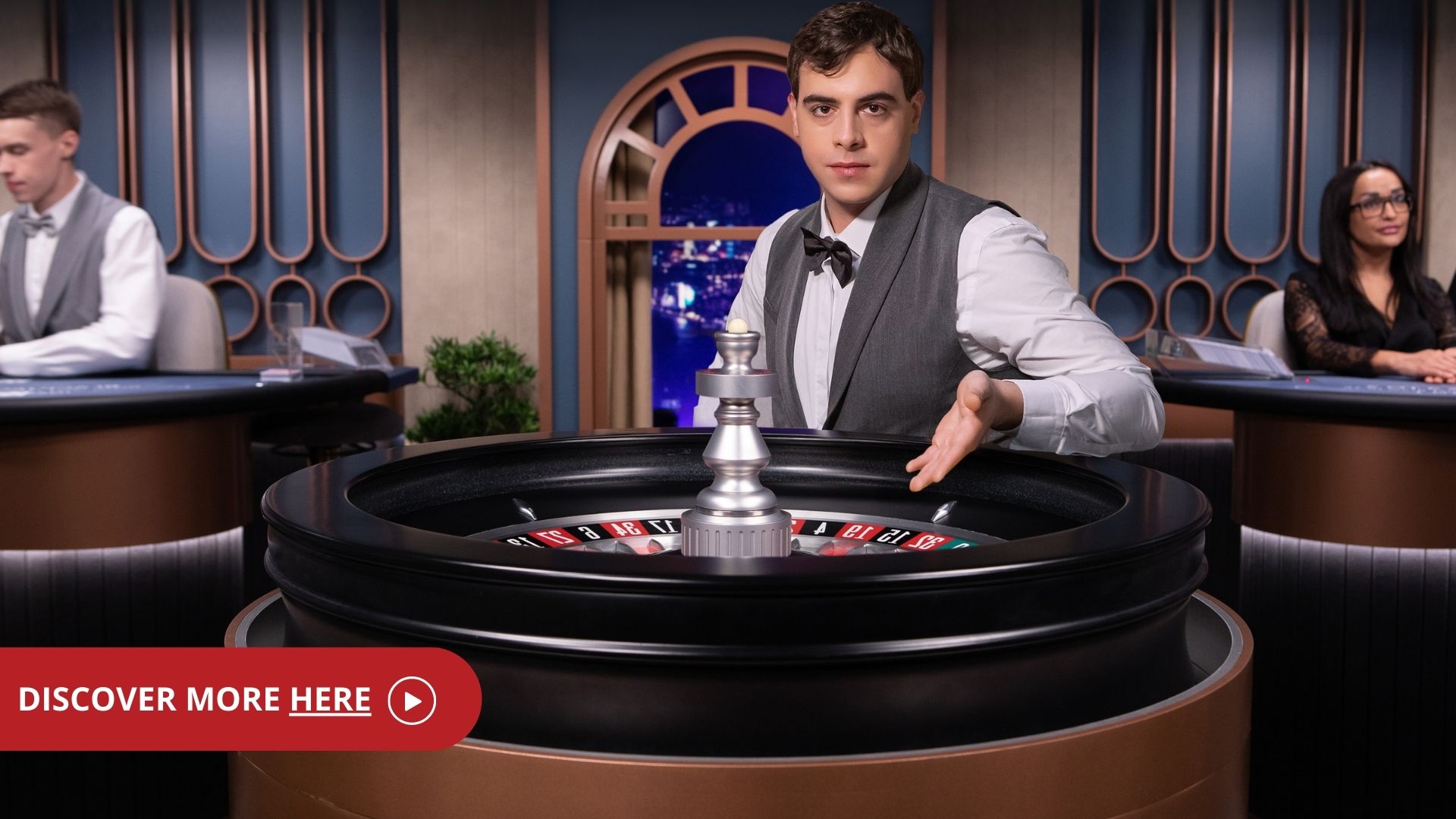 Male game presenter behind a roulette wheel in Speed Roulette reading 'discover more here'.